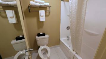 A bathroom with a toilet, a sink, a bathtub, and a shower curtain.