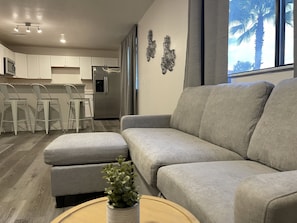 Deluxe Suite | Living area | 40-inch LCD TV with cable channels, TV