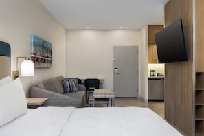 Premium bedding, desk, laptop workspace, blackout curtains