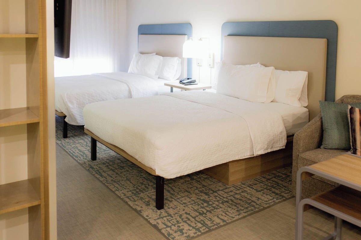 Premium bedding, desk, laptop workspace, blackout curtains