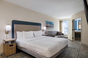 Premium bedding, desk, laptop workspace, blackout drapes