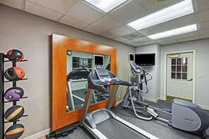 Stay fit on the go with a fully equipped fitness room featuring a treadmill, elliptical machine, and wall-mounted TV.