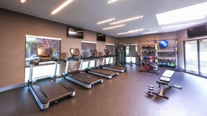 A gym with treadmills, a bench, dumbbells, and exercise balls. - Hampton Inn & Suites Seattle-Downtown (Seattle)