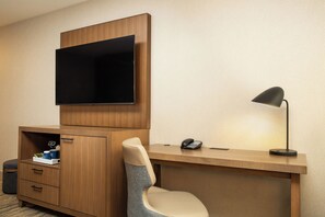A hotel room with a wooden desk, a chair, a television mounted above the desk, a telephone, and a lamp. - Four Points by Sheraton Downtown Seattle Center (Seattle)