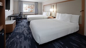 A hotel room with two beds, a desk, a chair, a TV, and a window with curtains. - Fairfield by Marriott Inn & Suites Seattle Sea-Tac Airport (SeaTac)