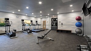 A gym with treadmills, a bench press, dumbbells, and exercise balls. - Fairfield by Marriott Inn & Suites Seattle Sea-Tac Airport (SeaTac)