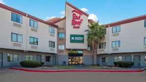 A Red Roof Inn with a sign for Home Towne Studios. - Red Roof Inn San Antonio - Seaworld/ Northwest (San Antonio)