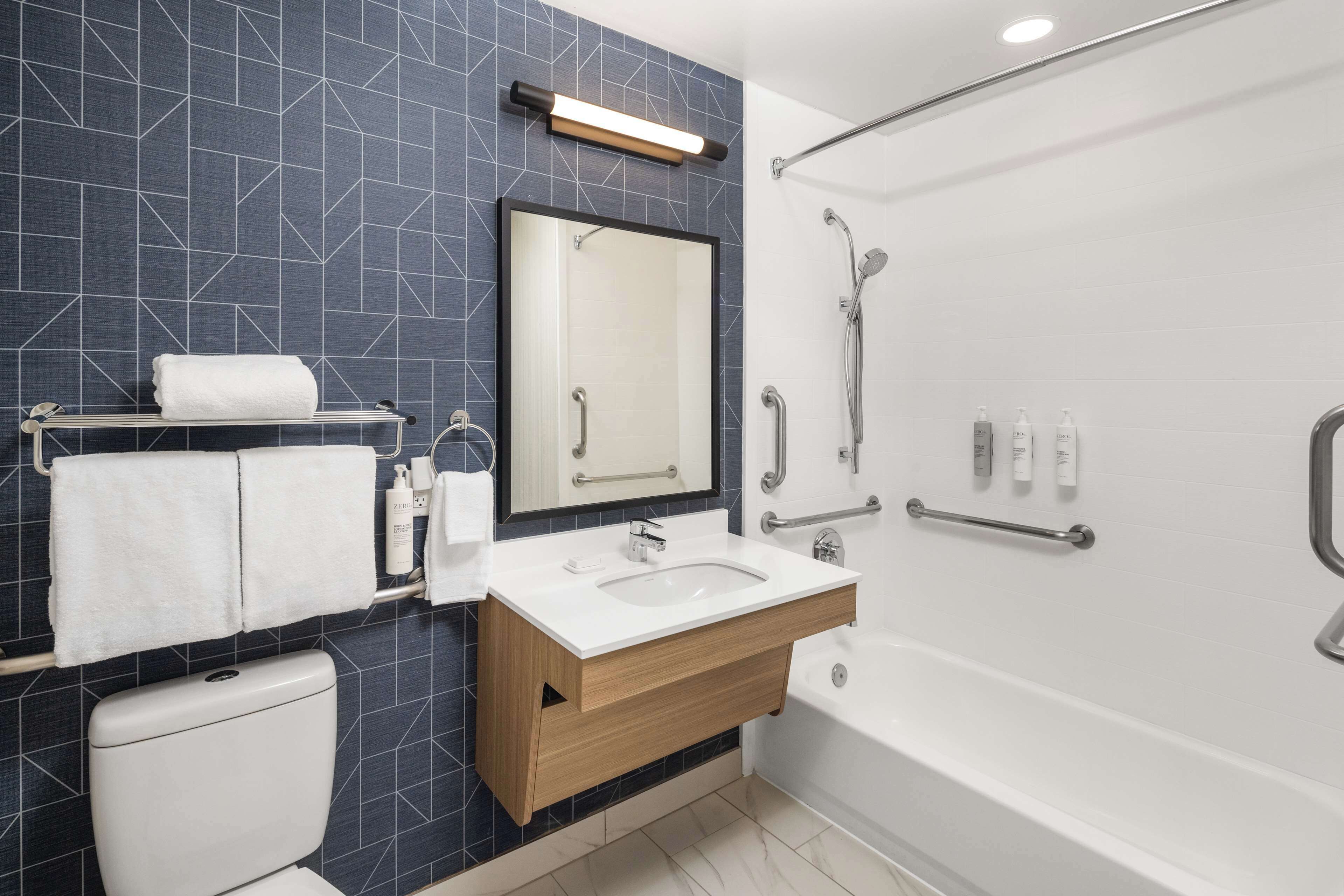 room, 1 king bed, accessible, bathtub (mobility) | bathroom | combined shower/bathtub, free toiletries, hair dryer, towels