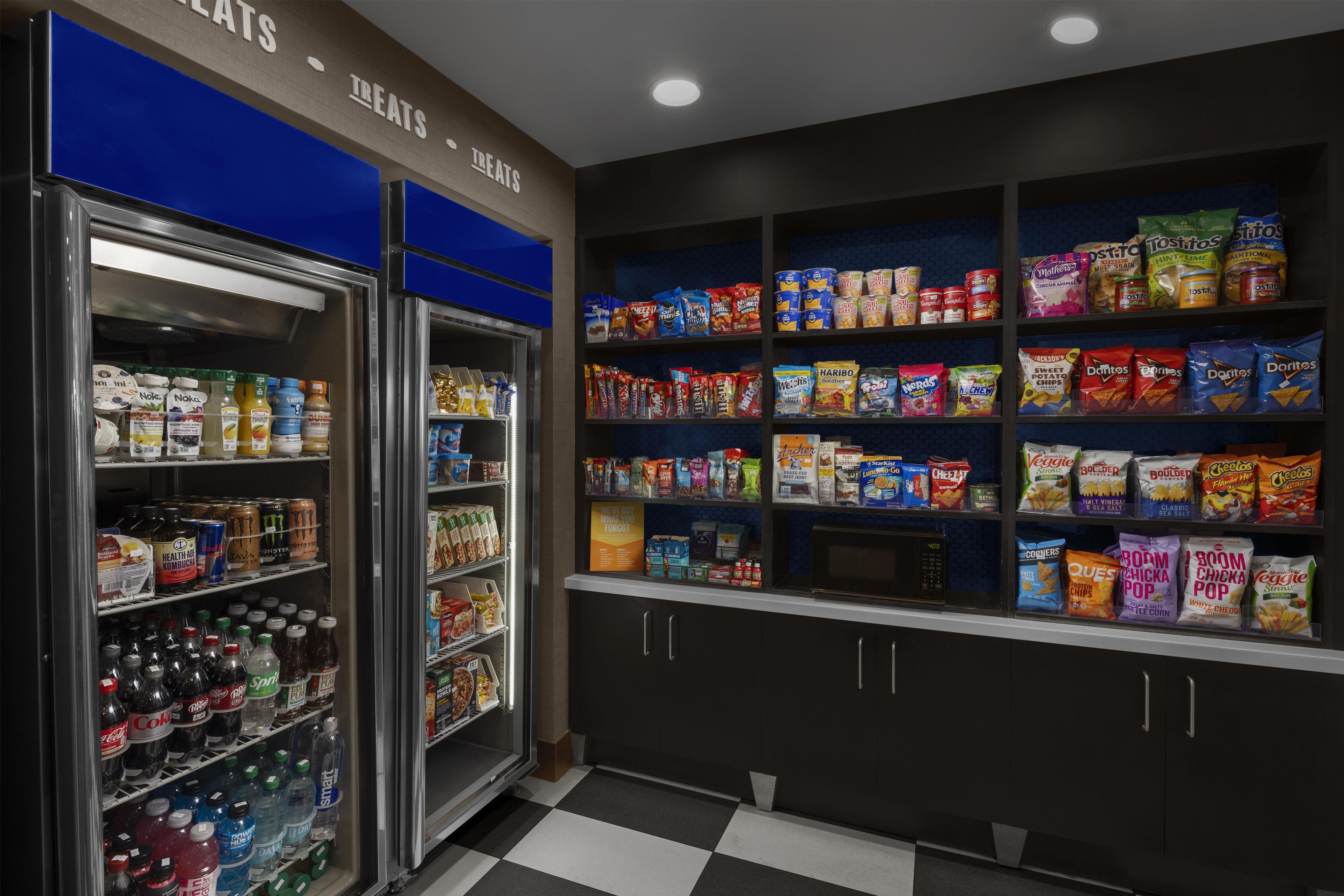 A snack vending area with various packaged snacks and beverages.