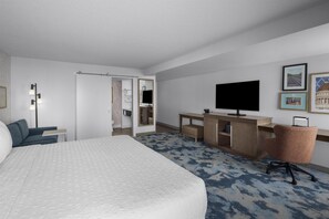 A hotel room with a bed, desk, chair, television, and artwork on the wall. - Hampton Inn Salt Lake City - Downtown (Salt Lake City)