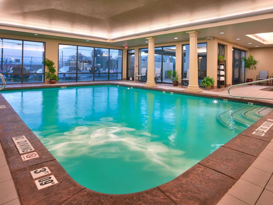 An indoor swimming pool with clear water, a no diving sign, and a 3ft depth marker.