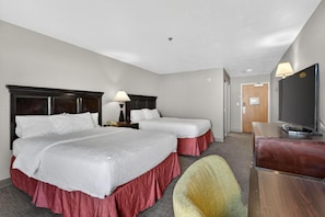A hotel room with two beds, a desk, a TV, and a chair. - Hotel SLC (Salt Lake City)