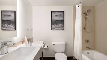 A modern bathroom with a bathtub, toilet, and sink.