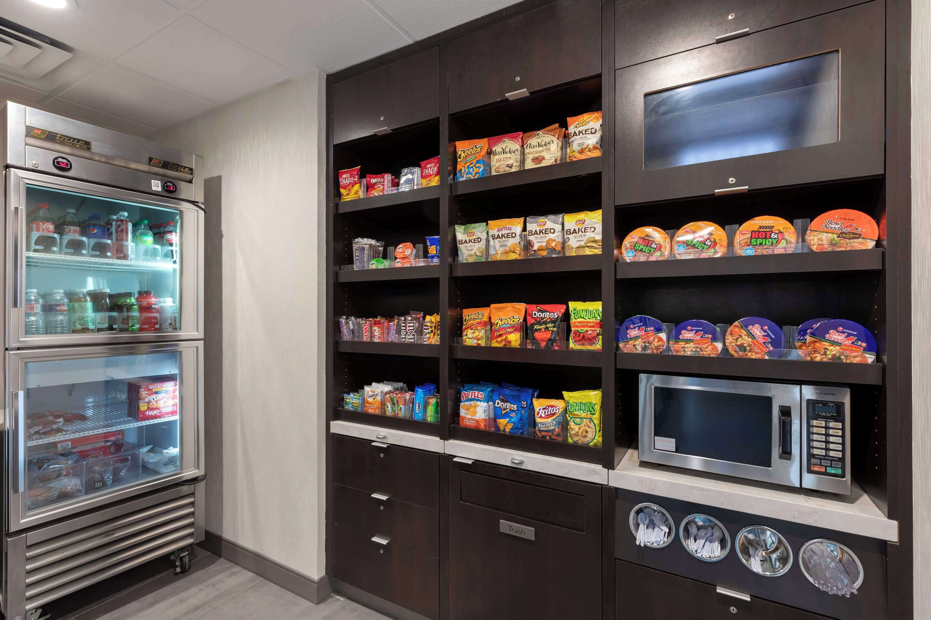 A vending machine area with snacks and a microwave.