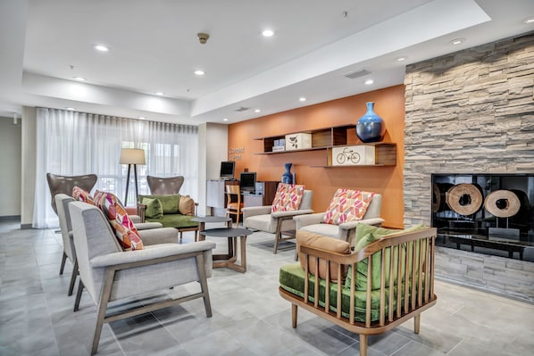 A modern living room with sofas, a coffee table, and a fireplace.