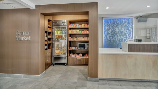 A corner market with refrigerated sections, a microwave, and a reception area. - Fairfield Inn & Suites Fort Worth/Fossil Creek (Fort Worth)