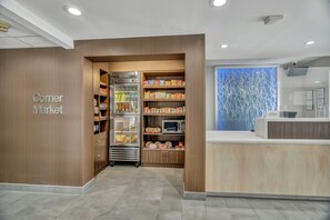 A corner market with refrigerated sections, a microwave, and a reception area. - Fairfield Inn & Suites Fort Worth/Fossil Creek (Fort Worth)