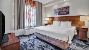 A hotel room with a large bed, a flat-screen TV, a desk, and a window with curtains. - Fairfield Inn & Suites Fort Worth/Fossil Creek (Fort Worth)