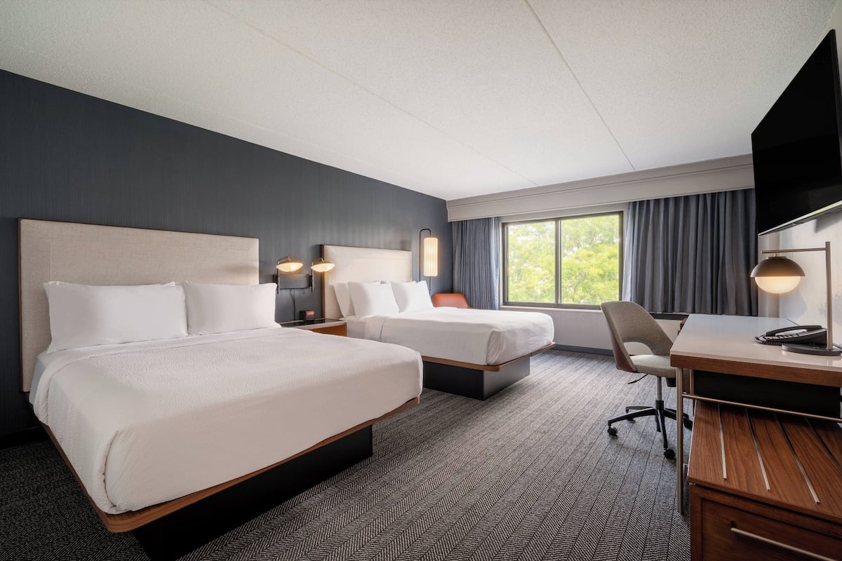 Premium bedding, pillow-top beds, desk, laptop workspace