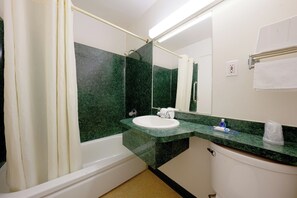 A bathroom with a bathtub, sink, and toilet.