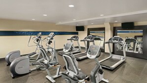 A gym with various cardio machines, including treadmills and elliptical trainers. - Hampton Inn Portland-Airport (Portland)