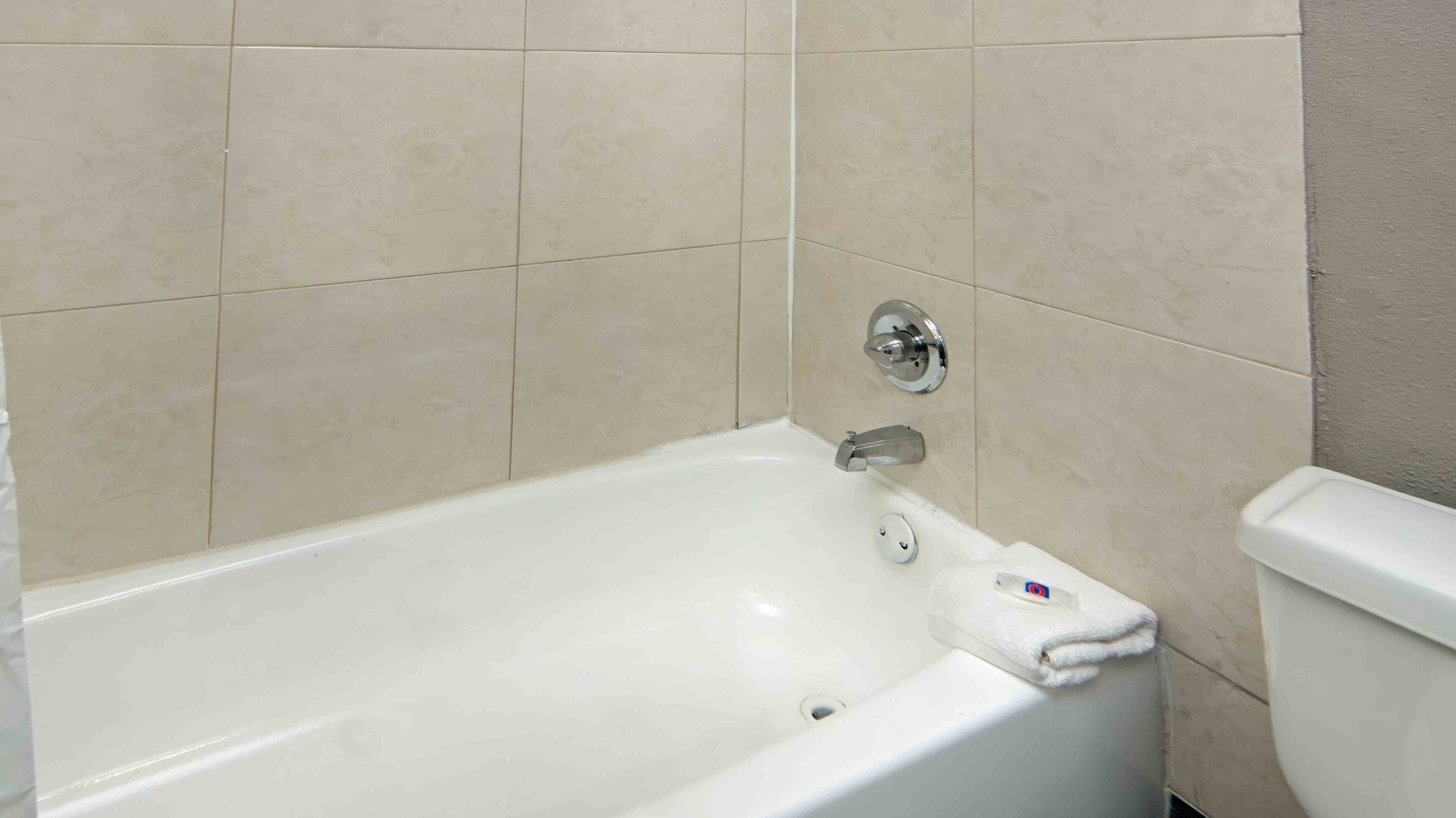 Combined shower/bathtub, towels, soap, toilet paper