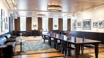 A spacious conference room with a long table, chairs, and a sofa.