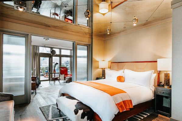 Relax in a spacious room with a large bed, city views, and a cozy reading nook.