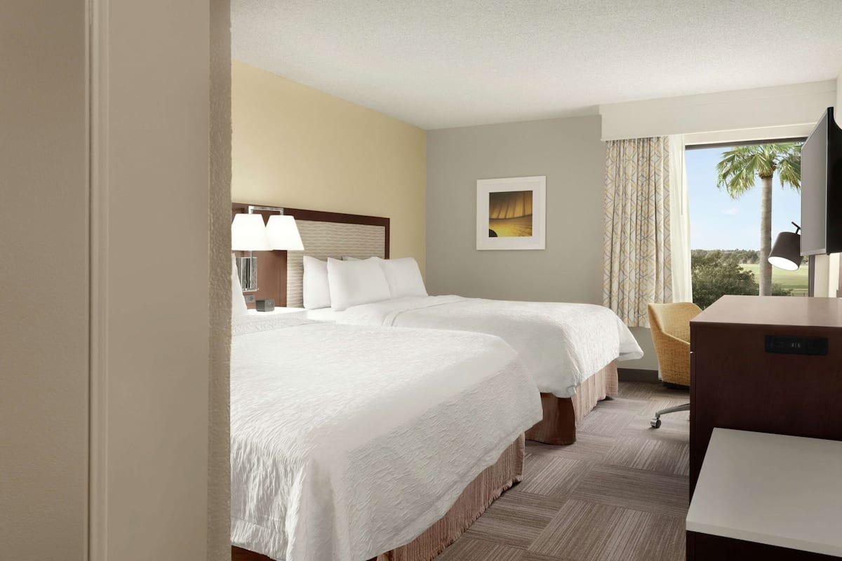 Hypo-allergenic bedding, desk, laptop workspace, blackout drapes