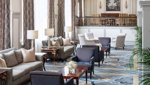 A spacious lobby with a grand piano, elegant chandeliers, and plush seating areas. - The Francis Marion Hotel (Charleston)