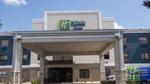 A Holiday Inn Express & Suites building with a covered entrance, stone pillars, and a parking area. - Holiday Inn Express & Suites Greenville Airport by IHG (Greer)