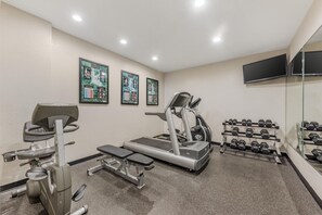 A gym with treadmills, weight benches, and dumbbells. - Best Western Alamo Suites (San Antonio)