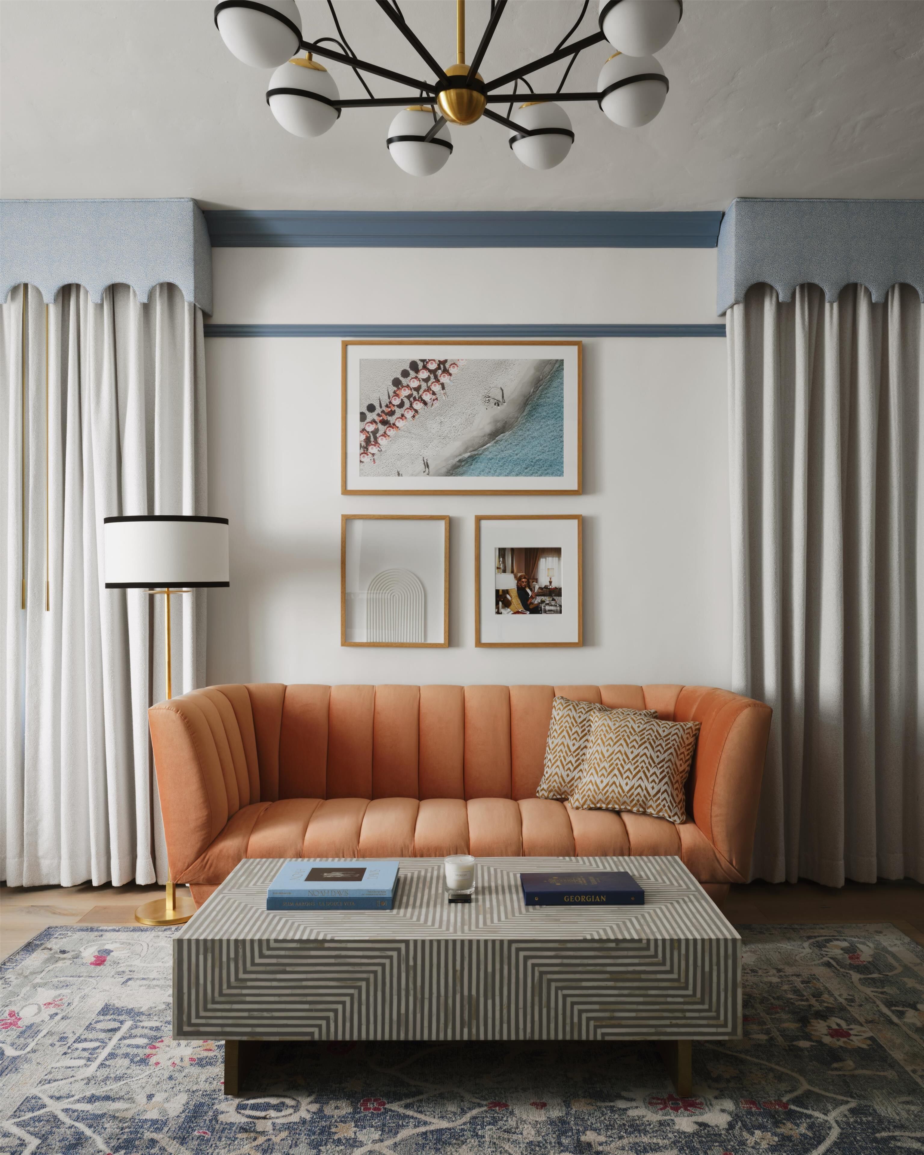 A modern living room with a sofa, coffee table, and framed artwork on the wall.