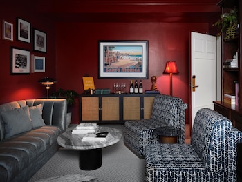 A home gym with exercise equipment, a treadmill, stationary bikes, a bench press, and dumbbells. at The Georgian, in The Unbound Collection by Hyatt