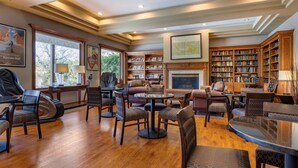 A spacious living area with a fireplace, bookshelves, and comfortable seating. - Best Western Plus Thousand Oaks Inn (Thousand Oaks)