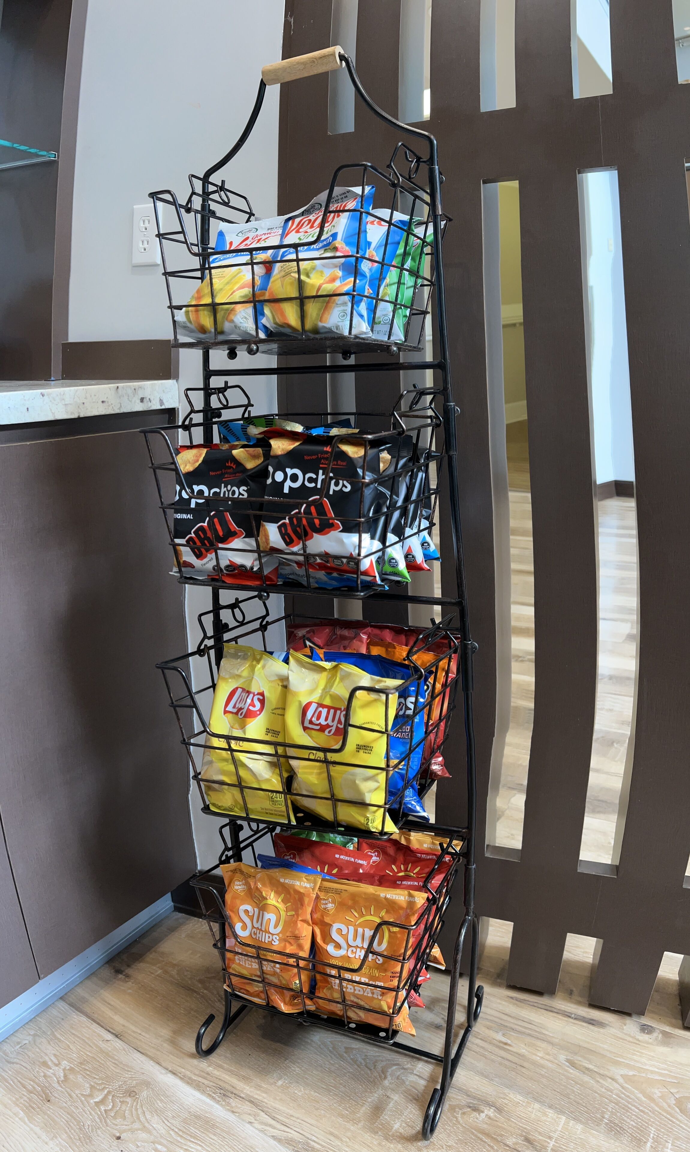 A snack display rack with various chips and snacks.