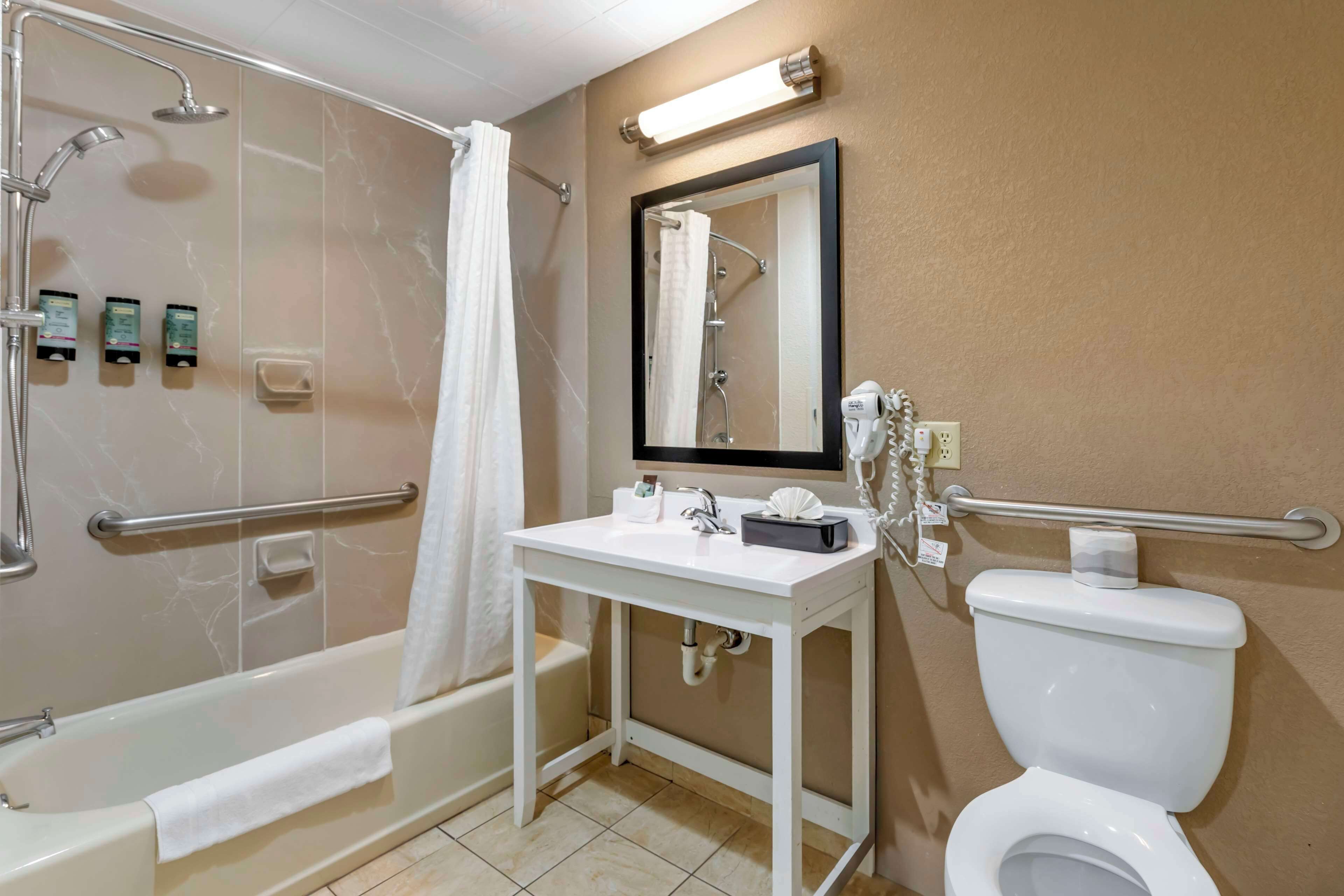 A bathroom with a bathtub, a sink, a toilet, and a shower.