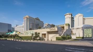 Un hotel con fachada moderna, una entrada destacada y una escalera que conduce al edificio principal.