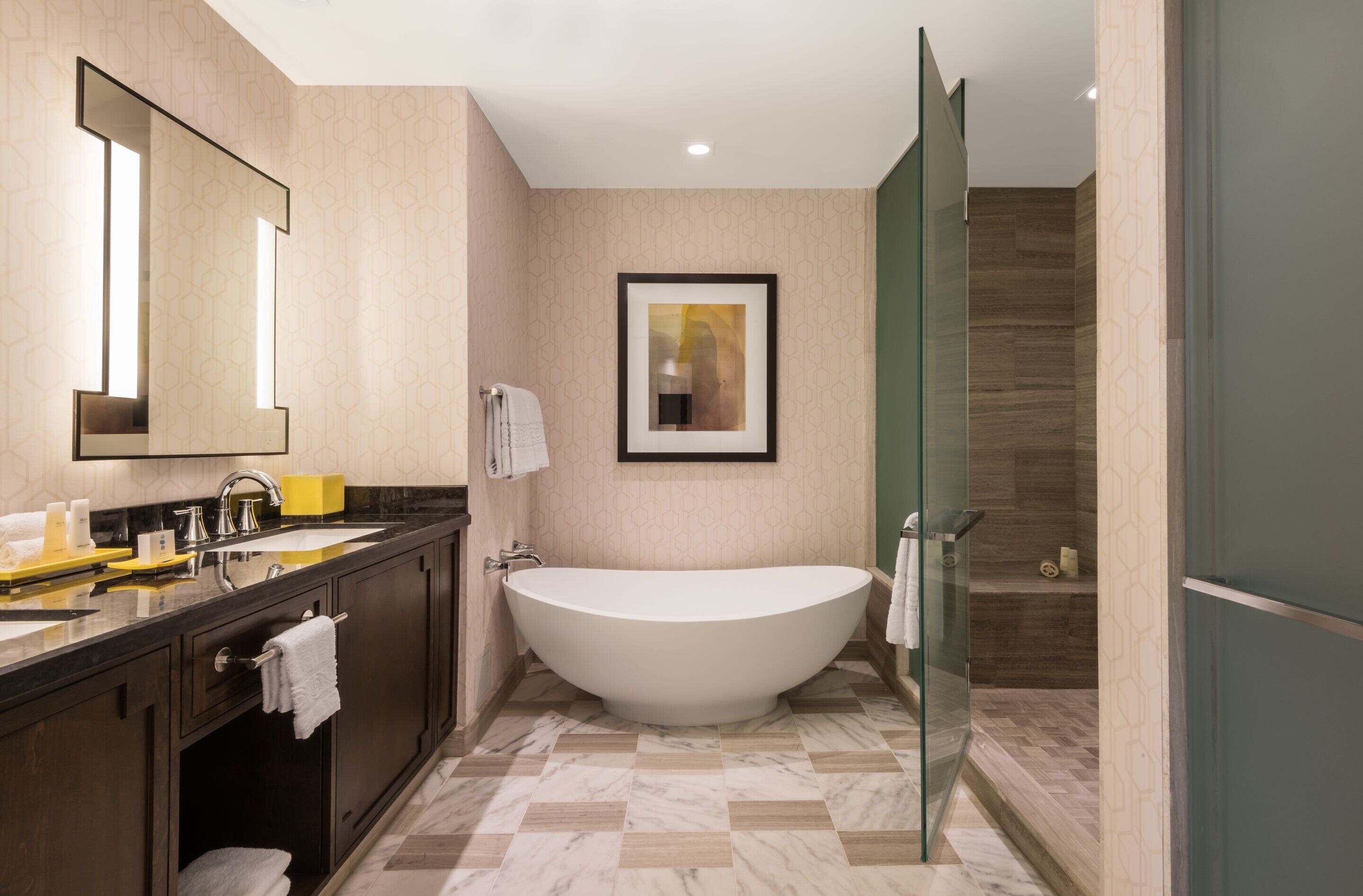 A modern bathroom with a freestanding bathtub, a large mirror, and a glass shower enclosure.