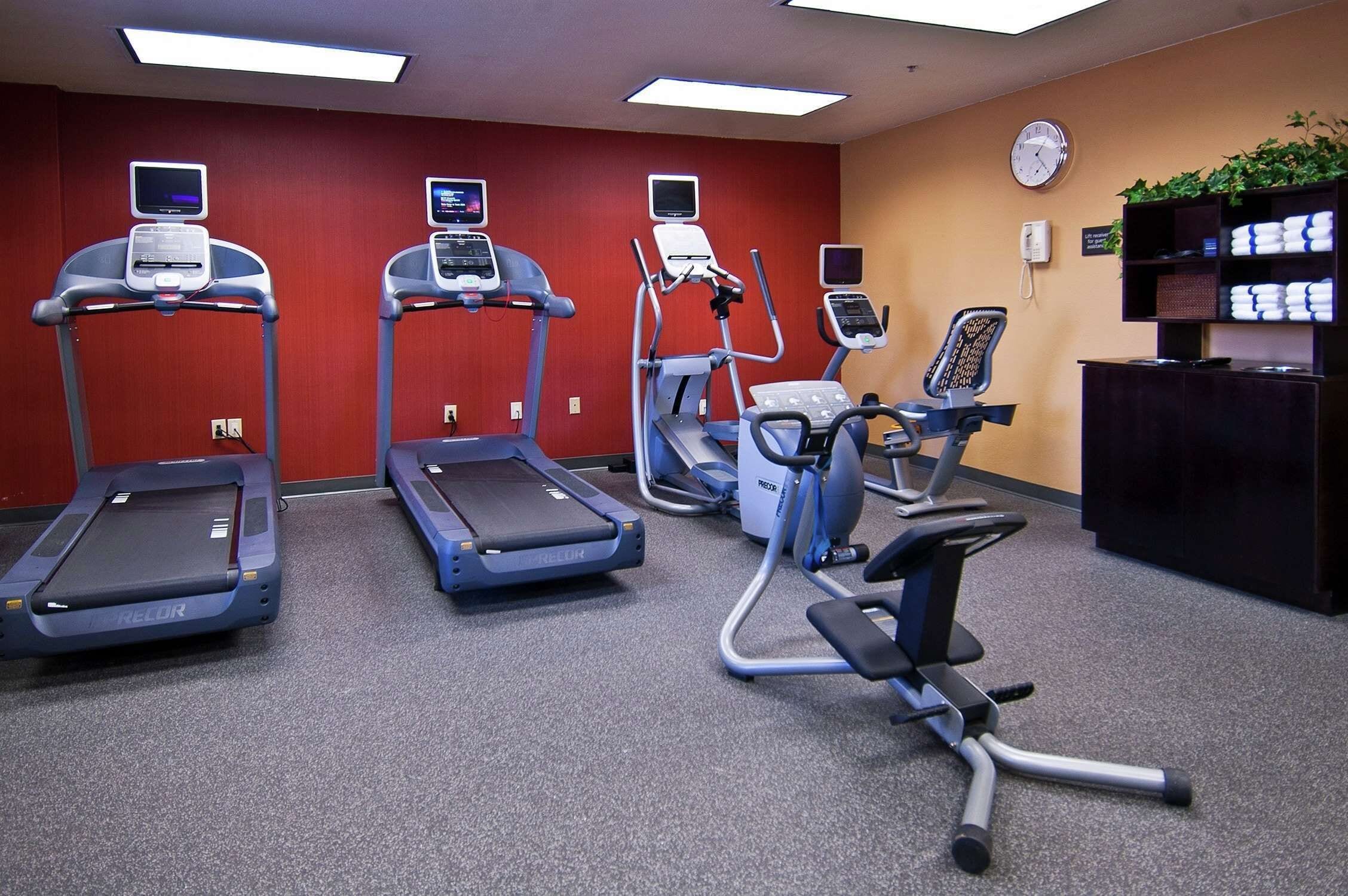 A fitness center with treadmills, an elliptical, and a stationary bike.