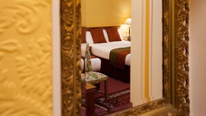 A hotel room with a bed, a chair, and a rug. - The Royal Highland Hotel (Inverness)