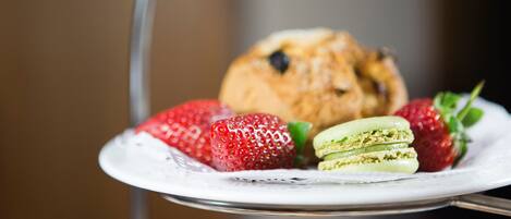 A plate with strawberries and a muffin.