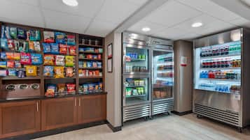 Un espace proposant des distributeurs automatiques de collations et de boissons, avec un assortiment de produits emballés.