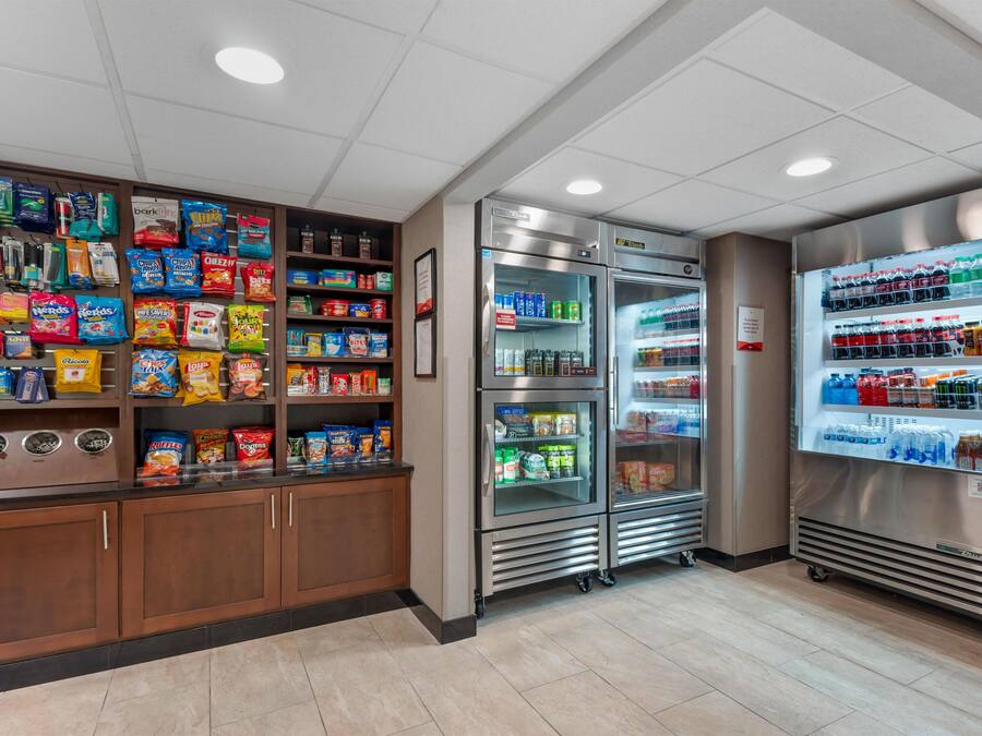 A snack and beverage vending area with various packaged snacks and drinks.