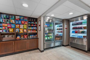 A snack and beverage vending area with various packaged snacks and drinks. - Drury Inn & Suites Austin North (Austin)