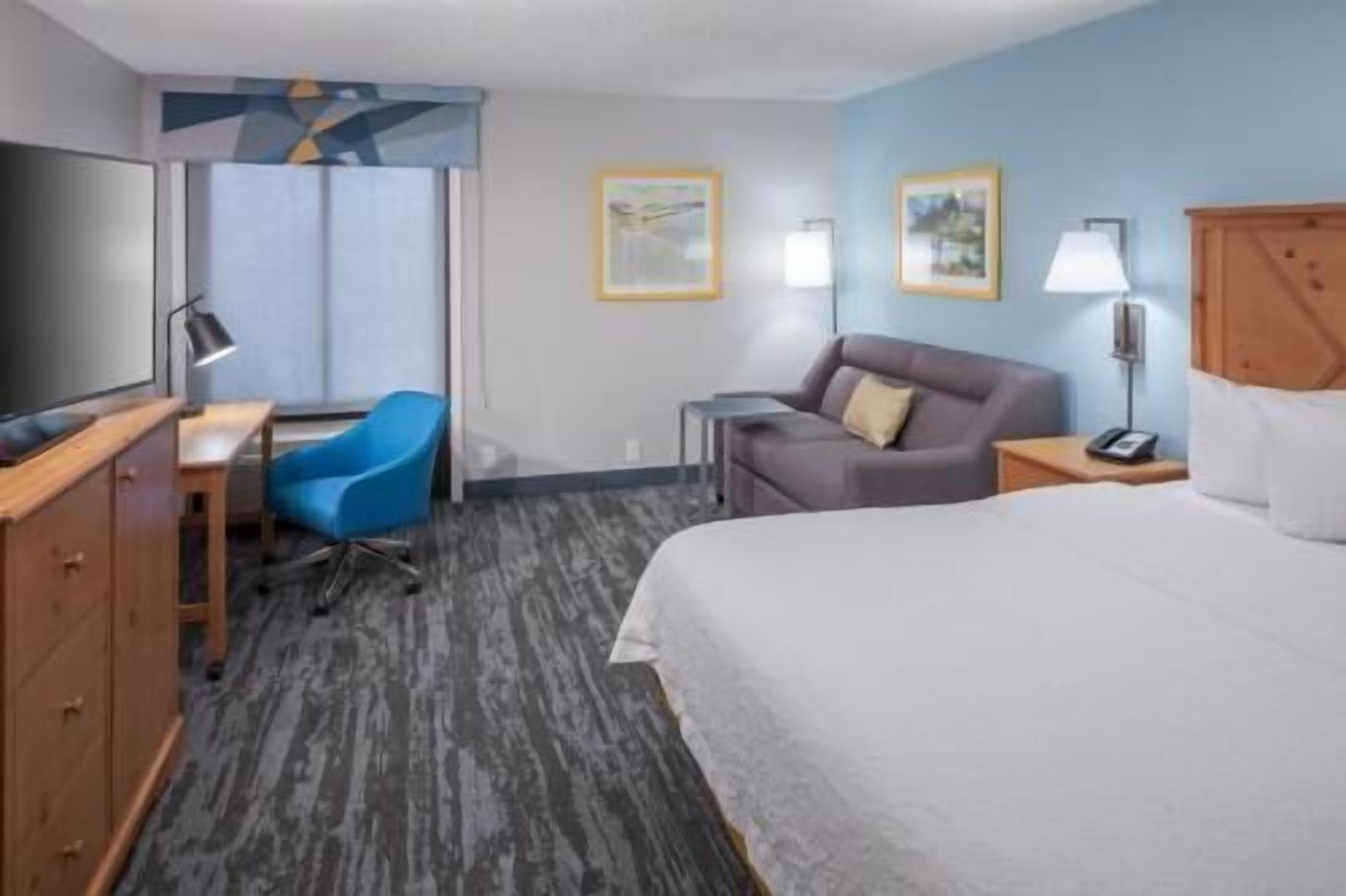 Premium bedding, desk, laptop workspace, blackout drapes