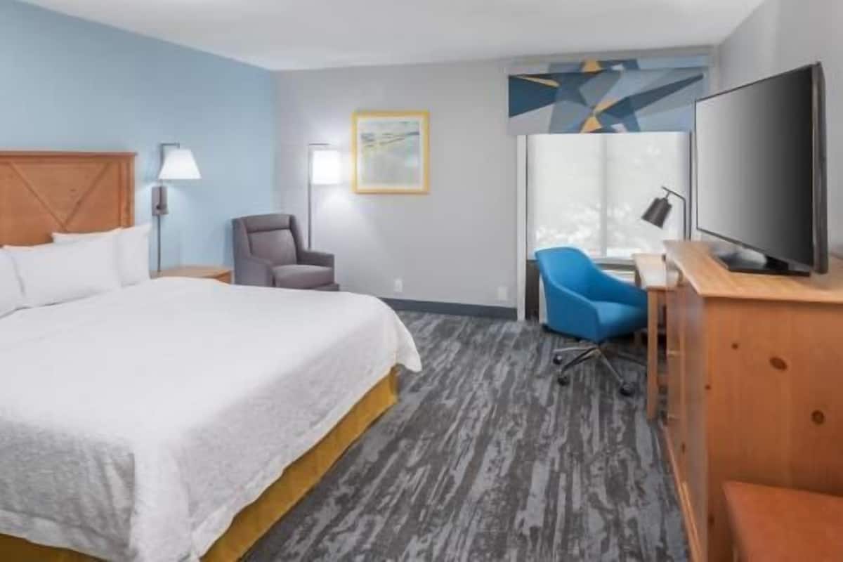 Premium bedding, desk, laptop workspace, blackout drapes