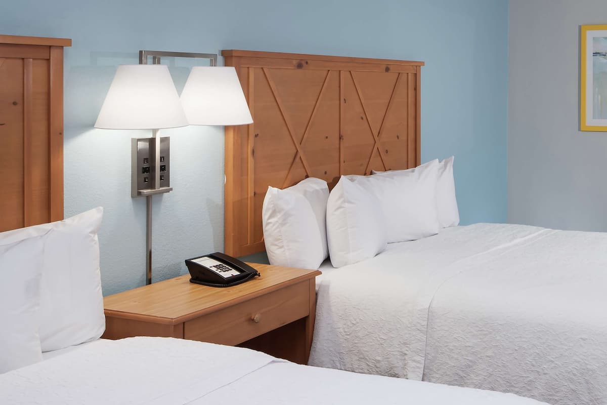 Premium bedding, desk, laptop workspace, blackout drapes