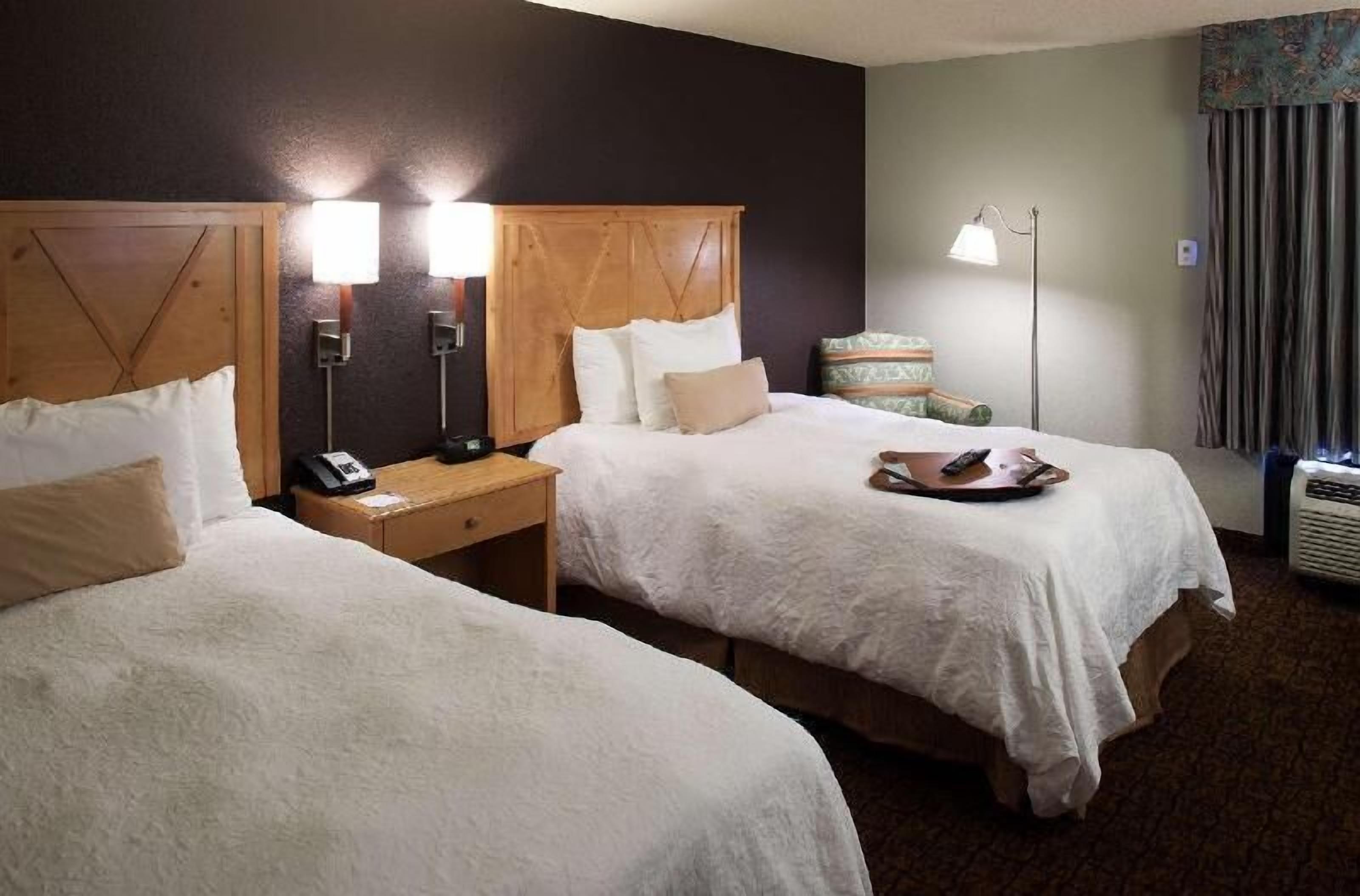 Premium bedding, desk, laptop workspace, blackout drapes