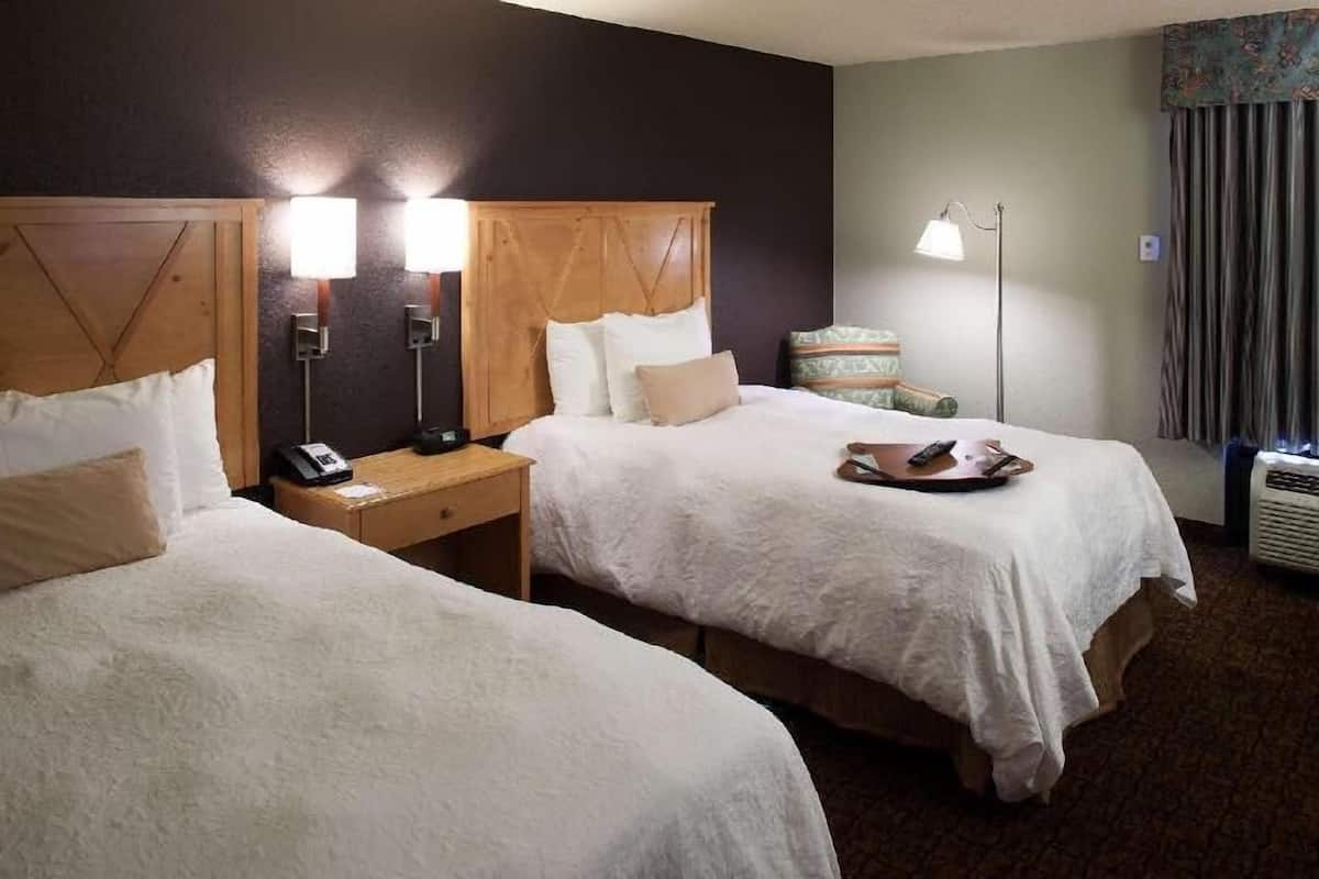 Premium bedding, desk, laptop workspace, blackout drapes